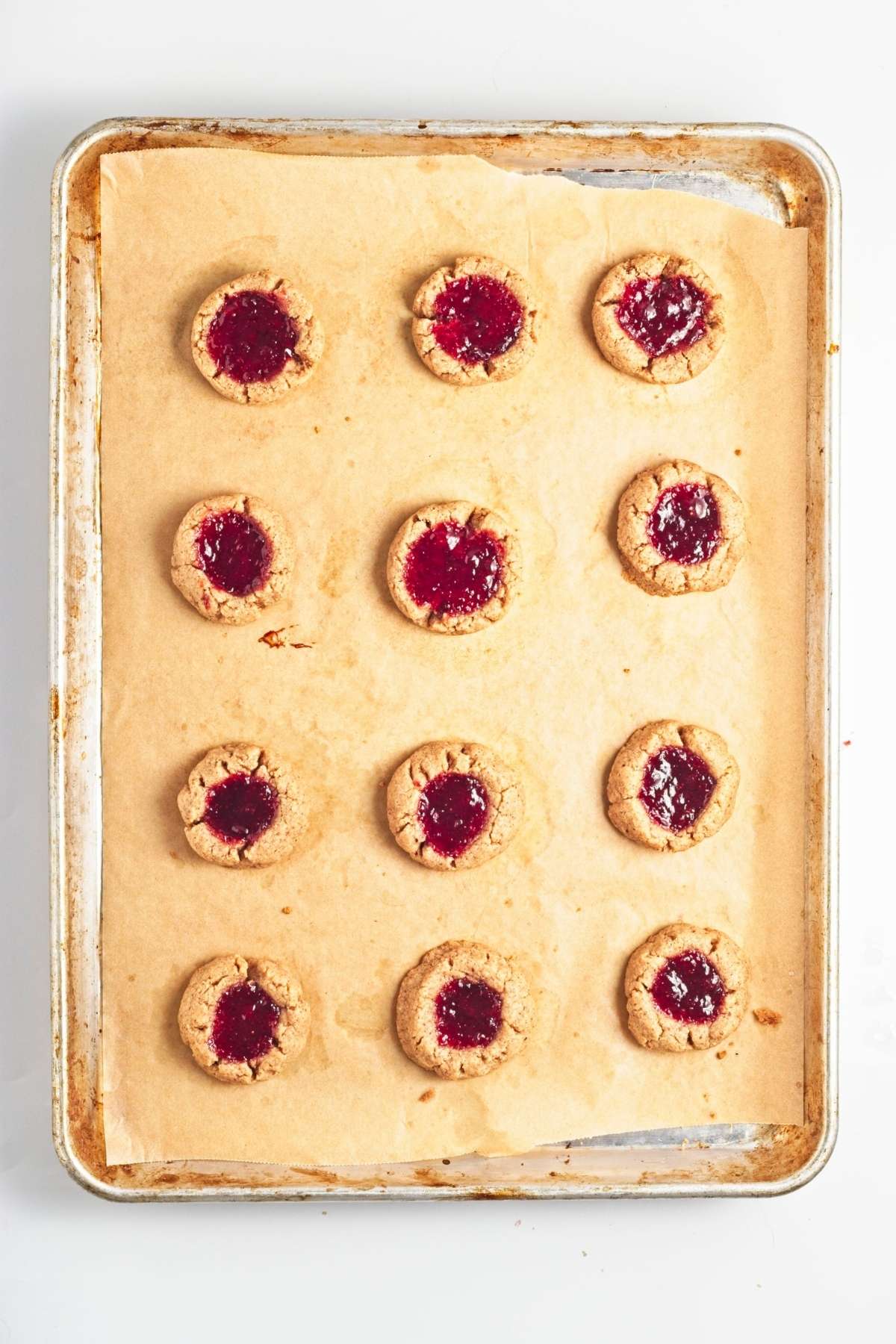 Strawberry almond thumbprint cookies cooling on a wire rack