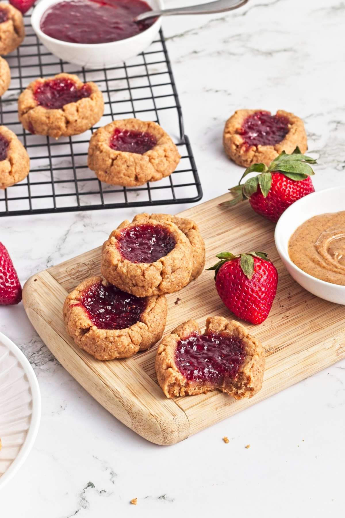 Strawberry almond thumbprint cookies with fresh strawberries and jam
