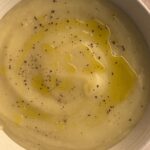 Creamy three-ingredient potato soup finished with a drizzle of olive oil and cracked black pepper in a ceramic bowl.