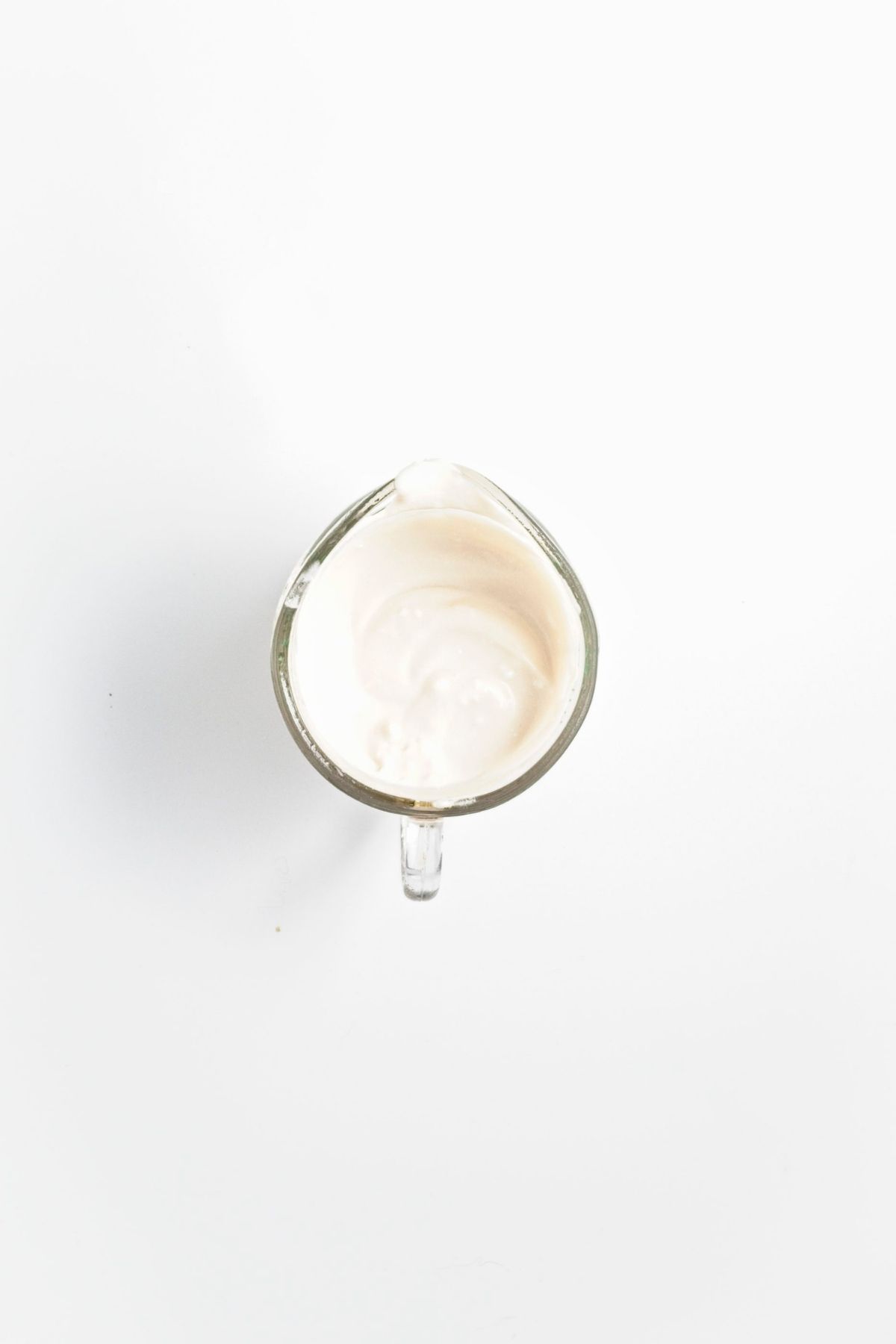 Coconut cream mixture in a small glass bowl.