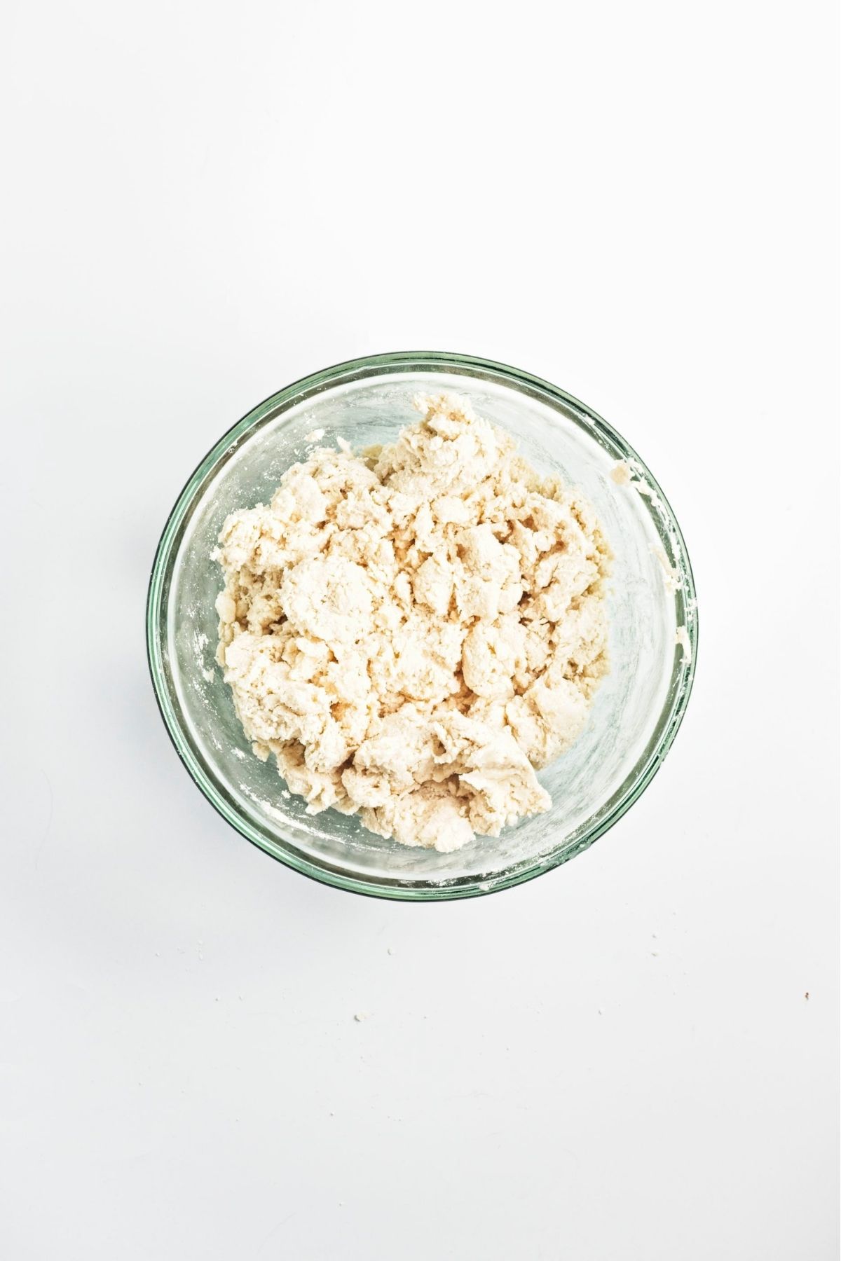 Shaggy scone dough in a glass mixing bowl.