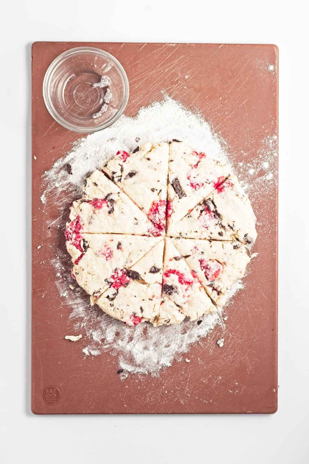 Round dough cut into eight wedges on a floured surface.