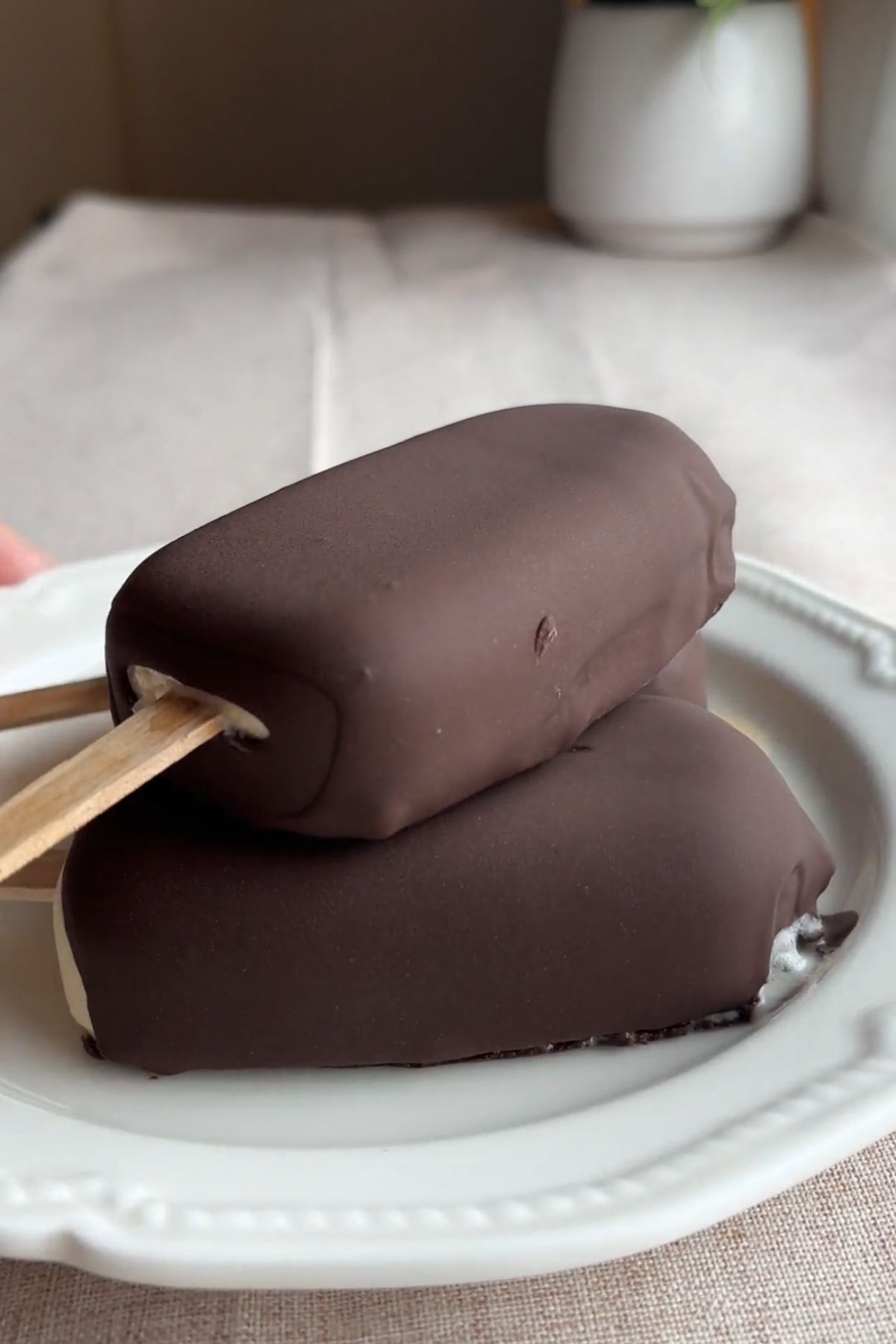 Vegan ice cream bar dipped in glossy melted chocolate for a thin snap shell