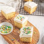Frosted cake squares topped with colorful sprinkles.
