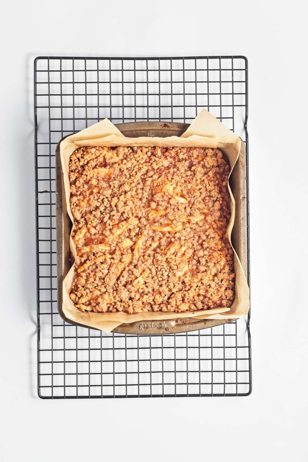 Baked crumble slab cooling in a pan on a wire rack.