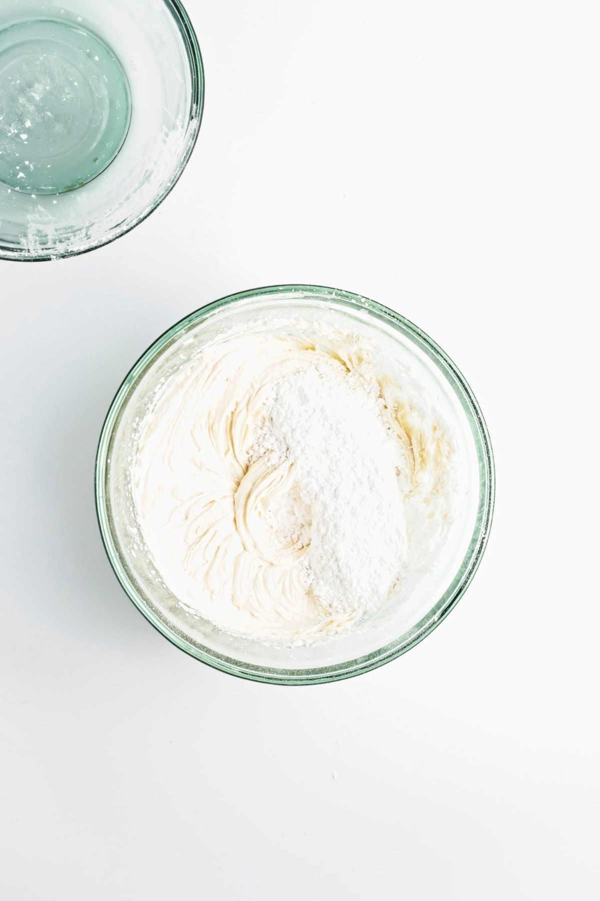 Wet and dry ingredients mixed in a glass bowl.