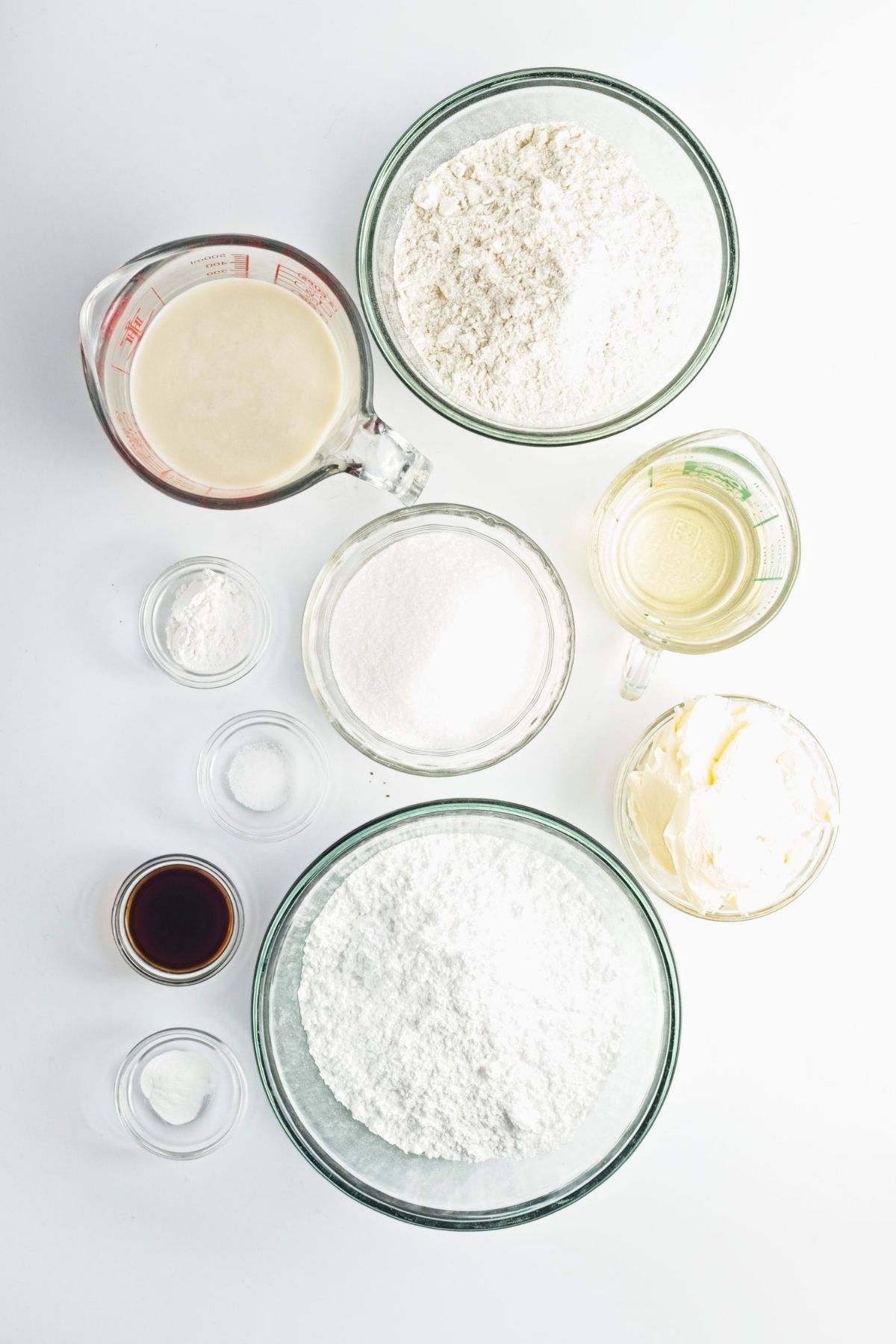 Cake and frosting ingredients arranged in bowls and measuring cups.