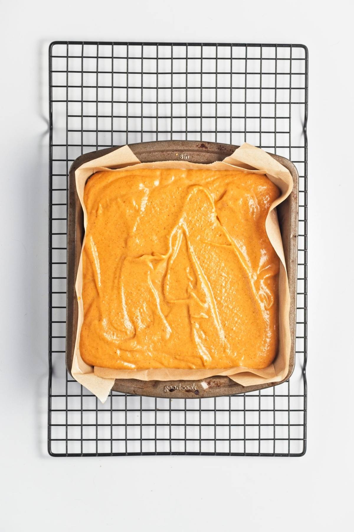 Pumpkin filling spread evenly over crust in a parchment-lined pan.