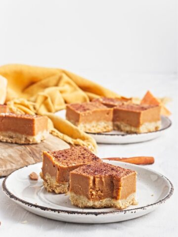 Sweet potato bars with a spiced filling and crumbly crust served on a plate.
