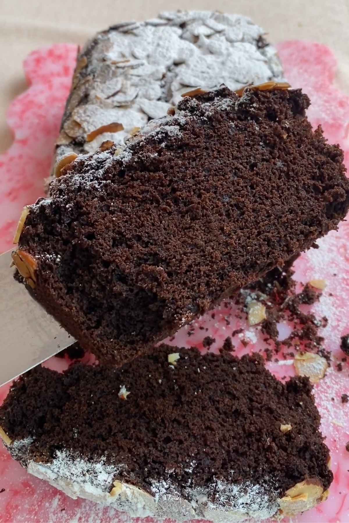Slice of chocolate olive oil cake showing its soft, moist crumb.