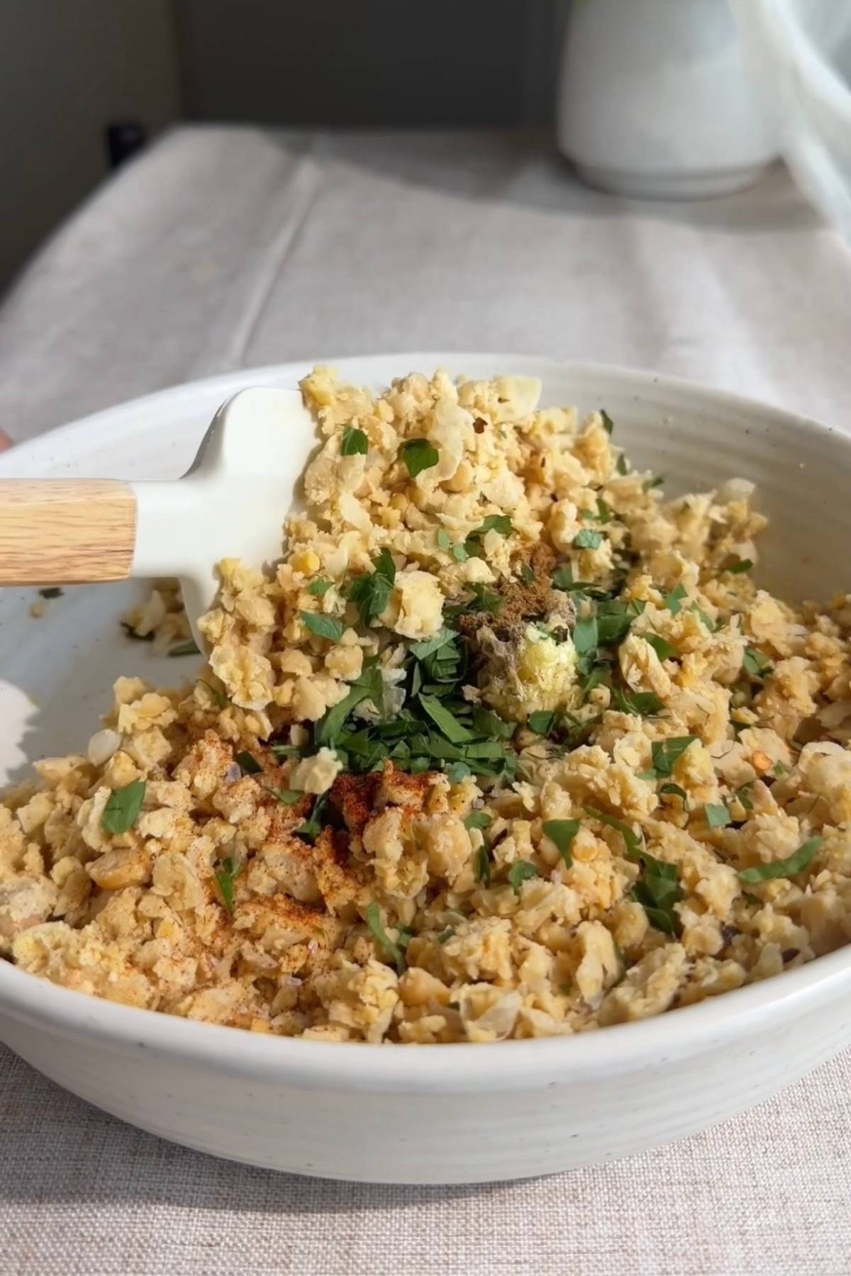 Mashed chickpeas topped with chopped parsley and chili flakes.