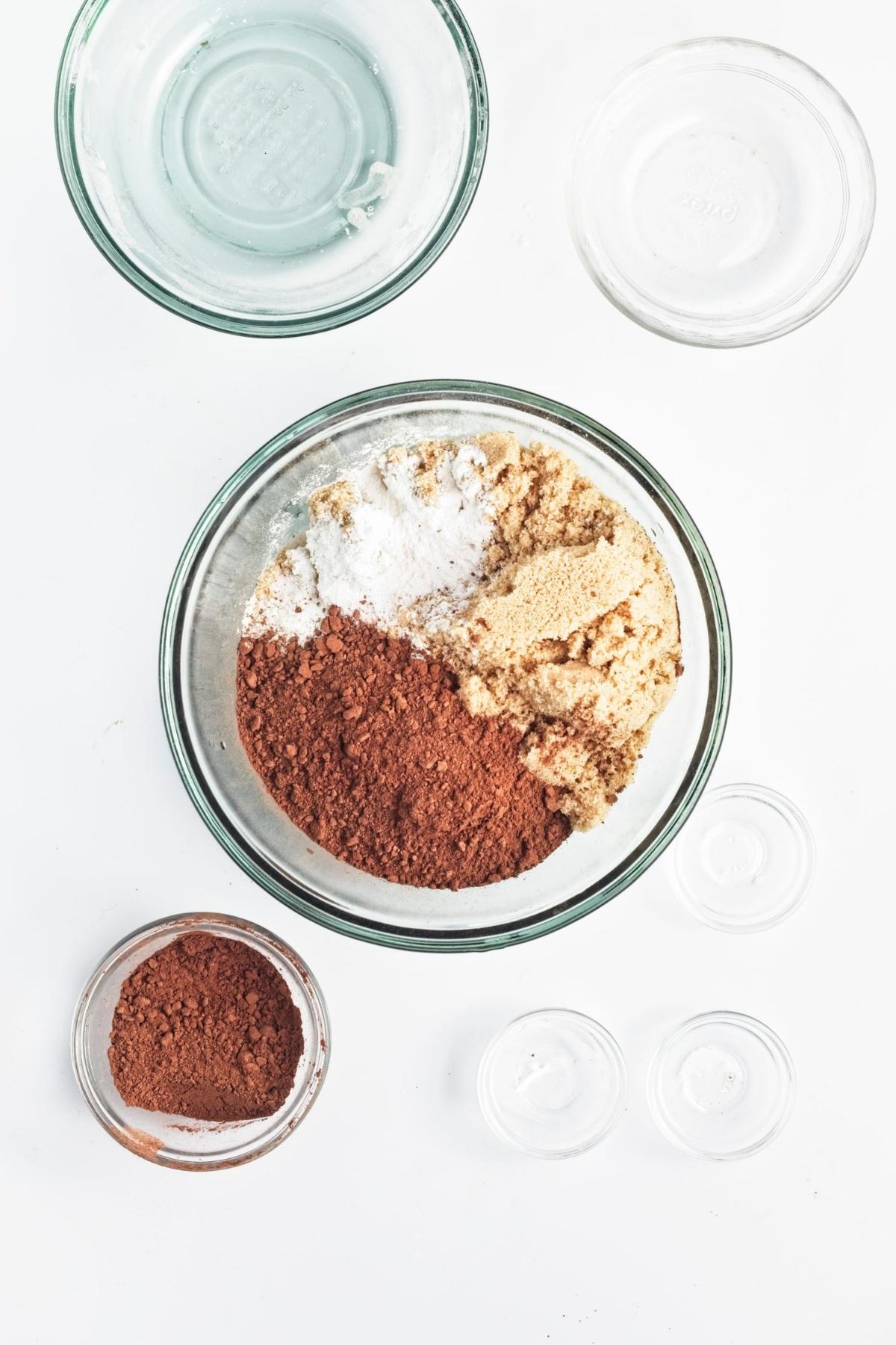 Dry ingredients portioned in a glass mixing bowl.