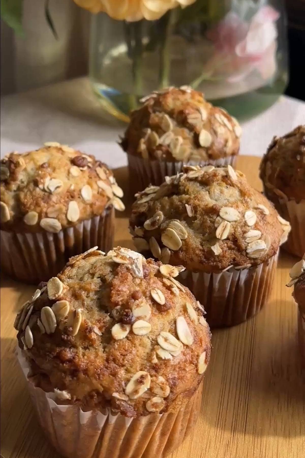 Freshly baked banana muffins topped with rolled oats.