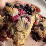 Large raspberry chocolate scone showing juicy raspberries and melted dark chocolate.