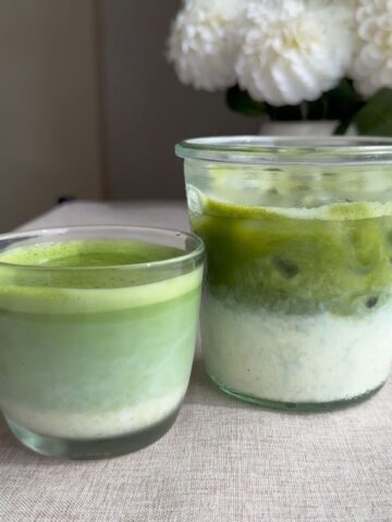 Hot and iced green lattes in glass cups.