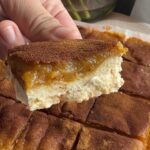 Close-up of a vegan sweet potato pie bar showing the creamy filling and crisp crust.