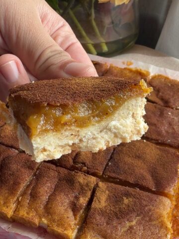 Close-up of a vegan sweet potato pie bar showing the creamy filling and crisp crust.