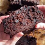 Slice of vegan chocolate zucchini bread showing a moist, chocolatey crumb.