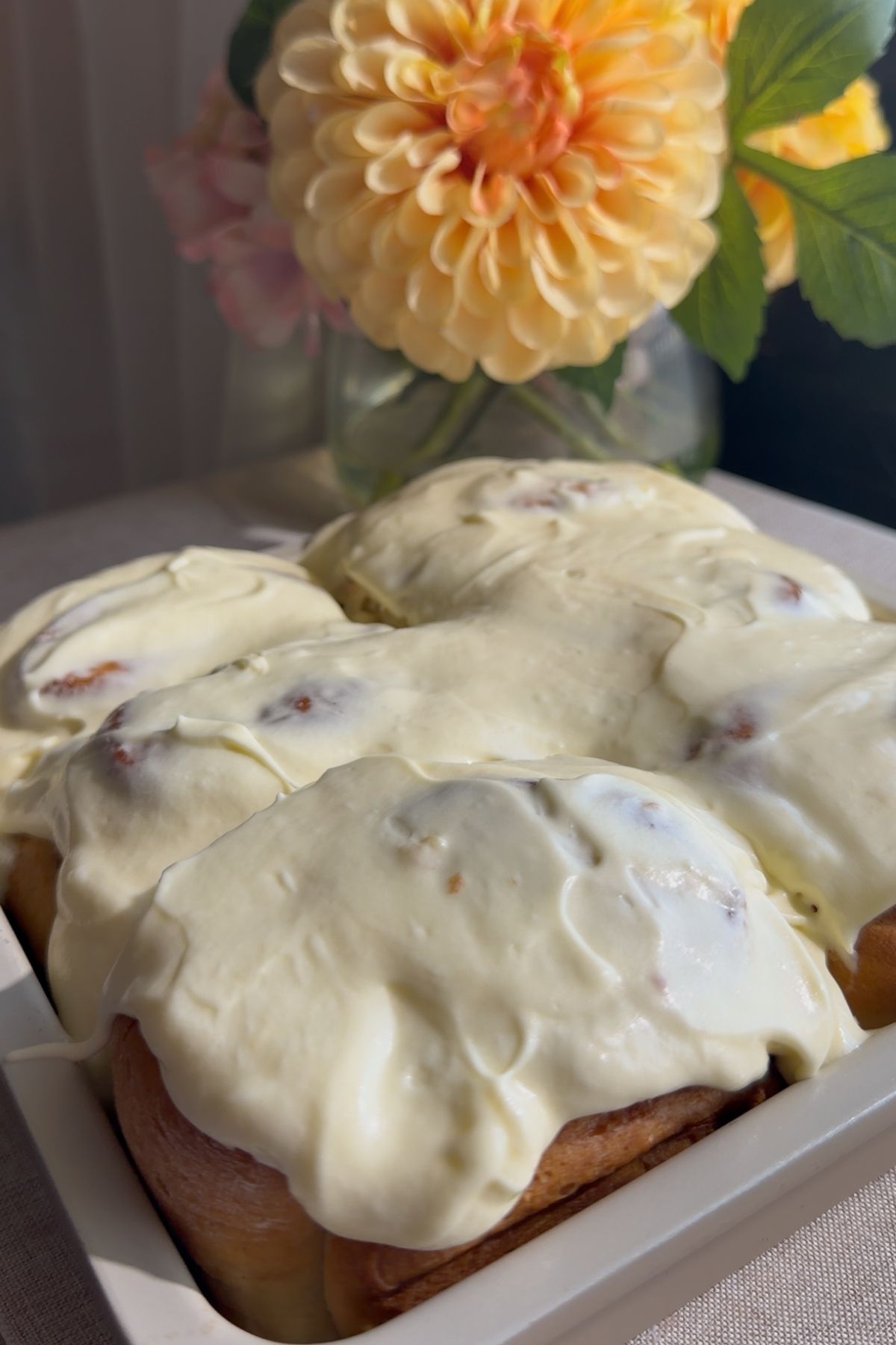Baked cinnamon rolls covered with thick cream cheese frosting.