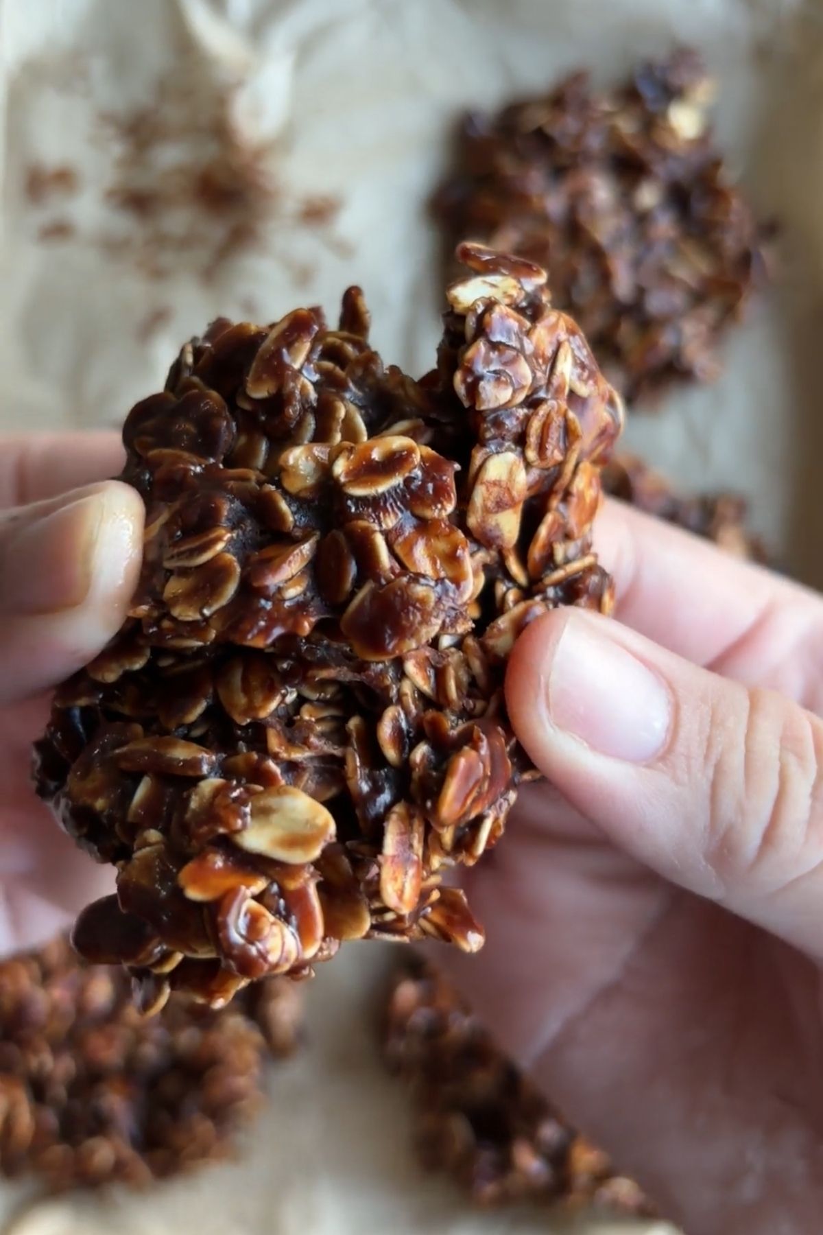 Chocolate no bake cookie broken in half to reveal the soft, fudgy center.
