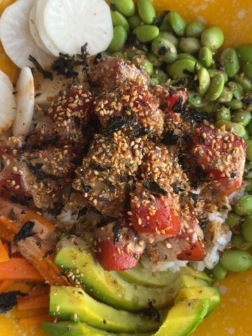 Watermelon poke bowl with avocado, edamame, rice, carrots, and sliced radish.