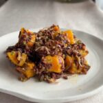 Wild rice salad with roasted butternut squash served on a white plate.