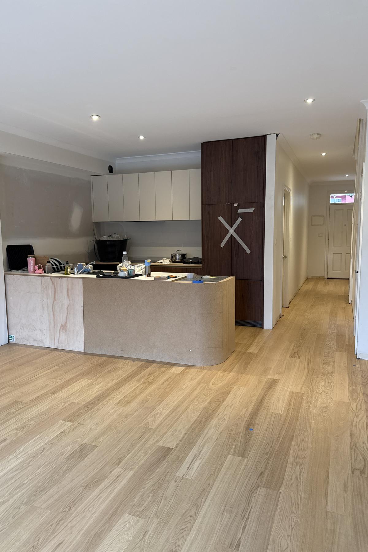 Finished oak floors running through an open plan kitchen, living area and hallway.