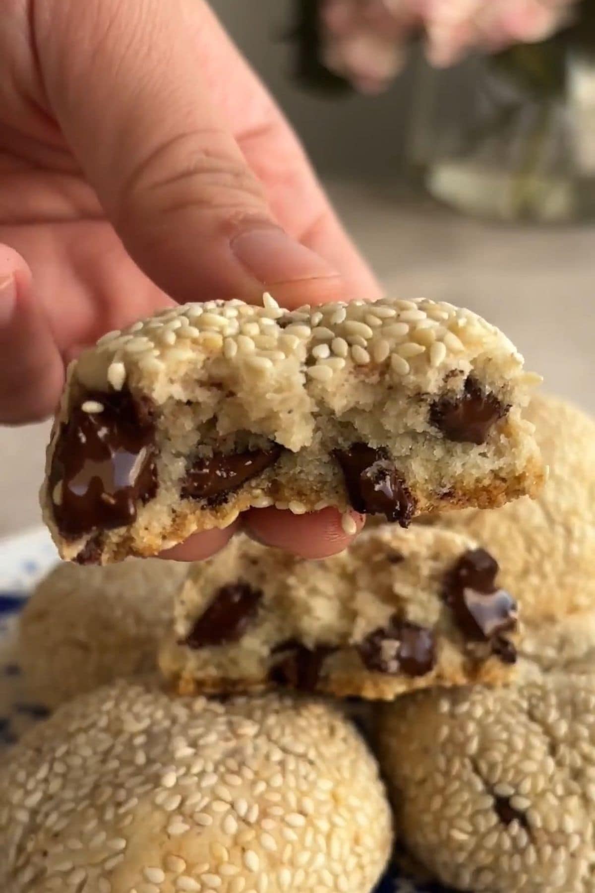 Two cookie halves stacked, revealing gooey chocolate chunks inside.