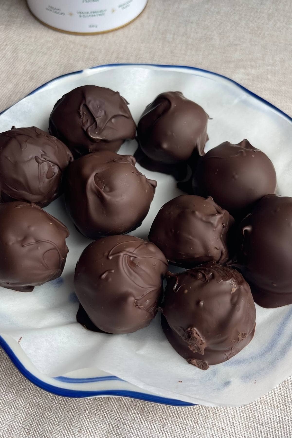 Chocolate-coated protein balls arranged on a plate.